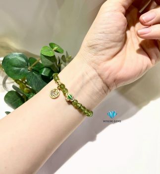 Vòng Peridot 6mm Mix Charm Đồng Si